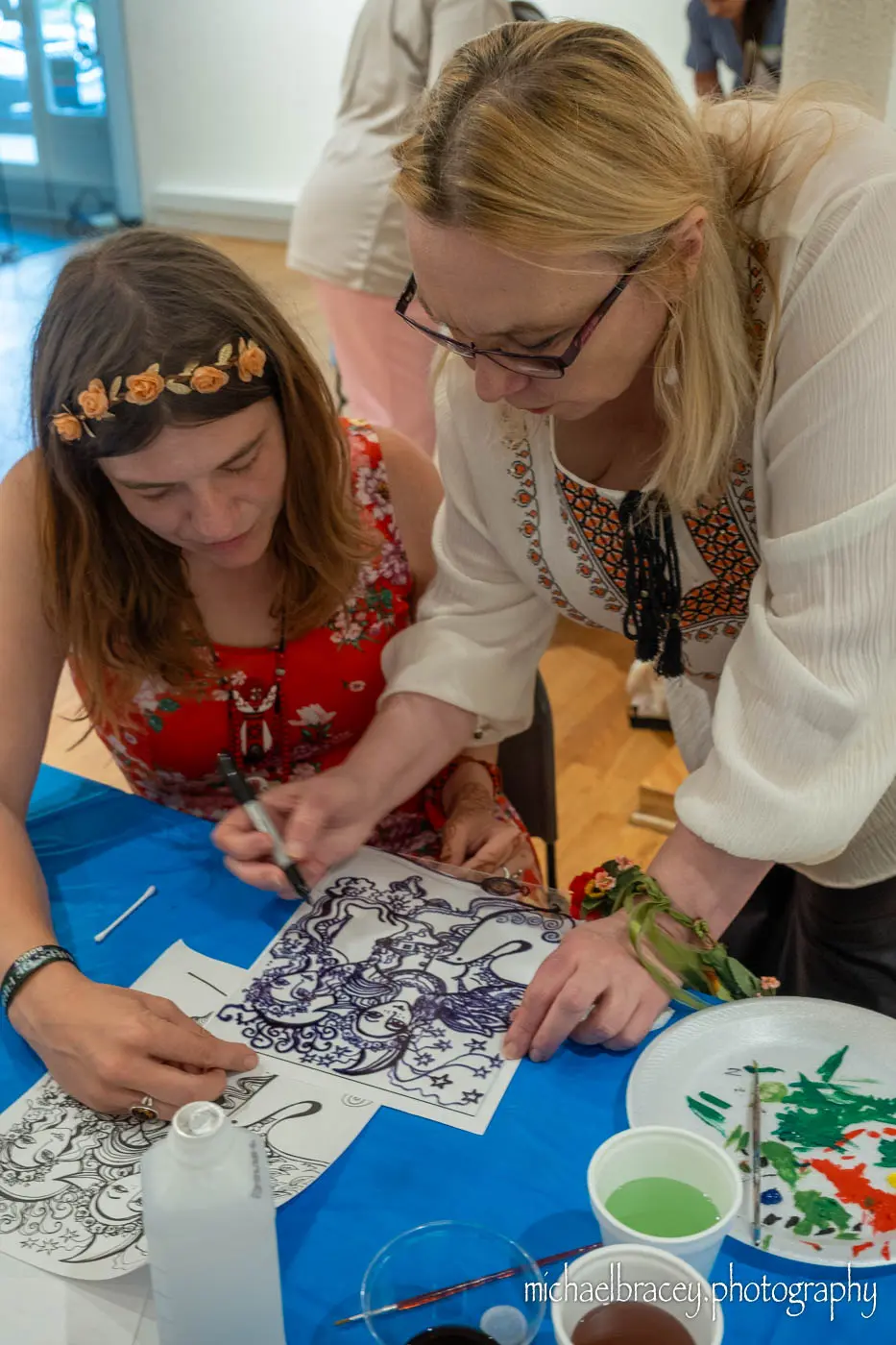 67cf41f3a85da_Elena5 (36b786bc-f82f-4606-bd54-4b745166b40b) A woman and girl are working on an art project.